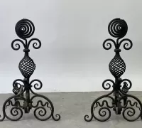 09A...A pair of Arts &amp; Crafts wrought iron andirons. 27-1/2in tall x 22in wide..