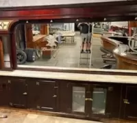 5A...Sixteen foot mahogany single arch back bar with stained glass accents on each corner top and original brass hardware. 9' High x 16' Long