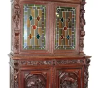 6N...Oak buffet with stained glass doors and full figural supports. 19th century. 94 1/2"h x 63 1/4"w x 26"d....
