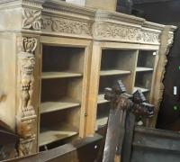 38A...Stripped   antique  carved  bookcase . 82  w  x   72 1/2"   h  x 17 deep   with  curved  deeper   glass  cabinet in the  center  .......