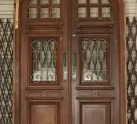 17H.....A PAIR OF WALNUT LEADED GLASS & IRON DOORS....99.5" H X 63.5" W X 4" D.....C. 1900